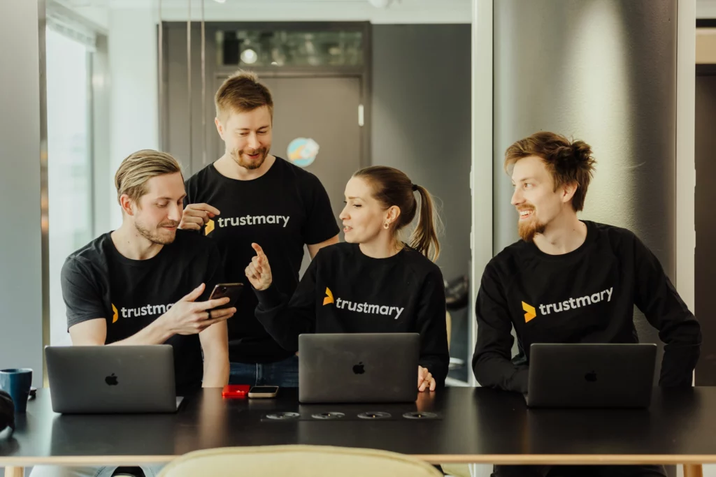 Trustmary people talking with each other while working
